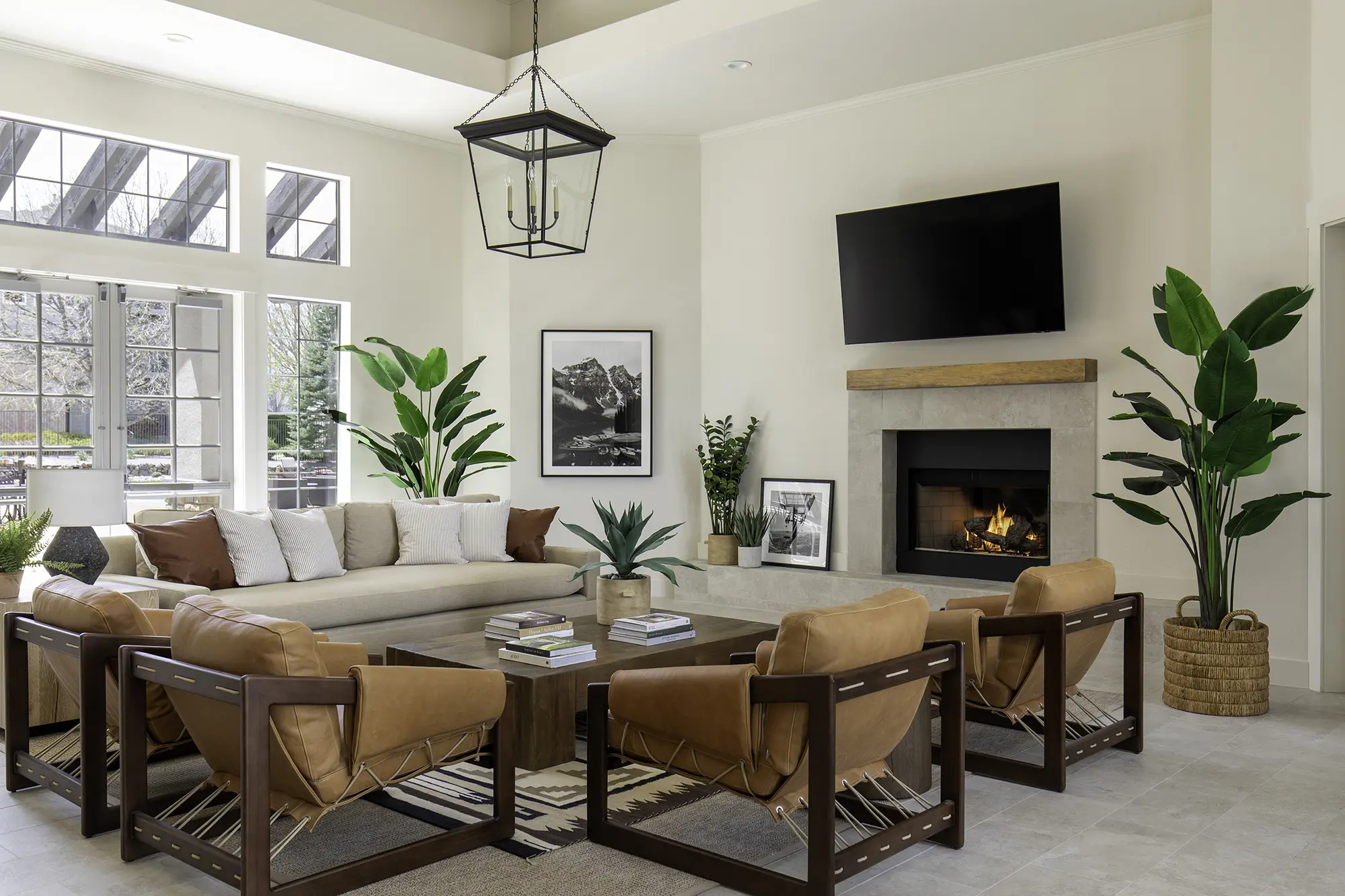 Bell Stonegate Community lounge with sofas and chairs around a fireplace and TV