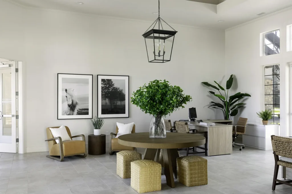 Bell Stonegate Leasing office lobby with arm chairs and tables