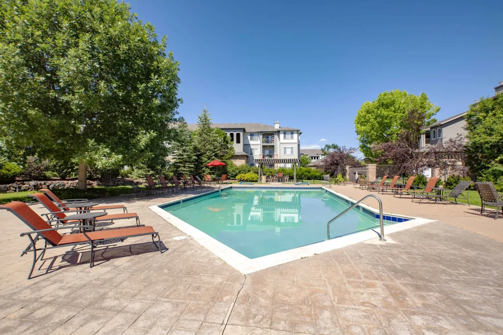 Bell Stonegate Swimming pool with seating and large trees